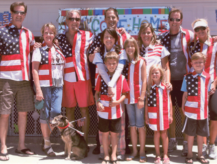 Dan Scully (third from left), his wife, Laney (second from left), their sons Brian (left), Dan IV (third from right) and Kevin (fourth from left) and their families celebrate the Fourth of July in Scully shirts from the company’s Patriot collection.