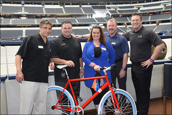 MLR Alliance’s Tony Pinto, Tony Tuso, Julia McDonald-Ward, Bill Reisack and Drew Ward show off the Solé bicycle given away in a drawing at the May 11 event. 