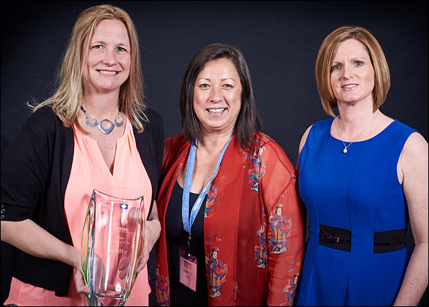 (From left) Christina Hamilton, account executive at SanMar and Susan Rye, director of strategic accounts at SanMar, receive the supplier's Supplier of the Year trophy with Vicki Palm, director of marketing at The Vernon Company.