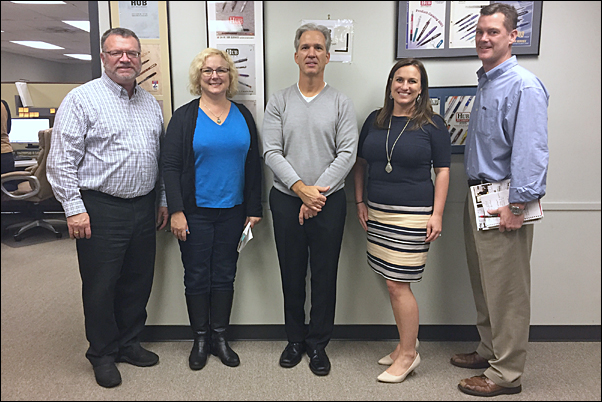 Cutline: Tucker (second from right) and Baker (center) got an up-close look at Hub Pen’s Braintree, Massachusetts, facility and the supplier’s laser technology during their meeting with Executive Assistant and Marketing Copywriter Pam Baker (second from left); National Sales Manager Andy Arruda, MAS (left); and Vice President of Sales Mike Fleming.