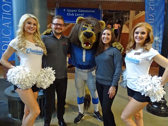 Cody Miller and Stefanie Poe from SAGE get a photo with Detroit Lions’ cheerleaders and the team’s mascot, ROARY.
