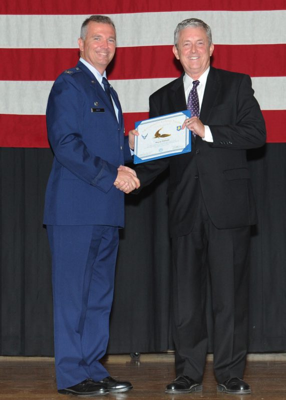 Wayne Roberts, right, receives the Golden Eagle award from Col. Ricky Rupp at McConnell Air Force Base in Kansas.