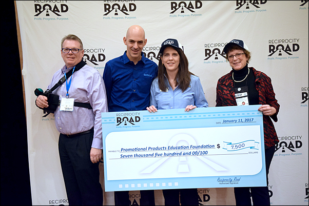 Reciprocity Road’s Rod Brown, MAS, president of MadeToOrder (left) and Jeremy Lott, SanMar, present a check for PPEF to Sara Besly, PPEF Foundation manager and Pat Dugan, MAS, PPEF chair, during The PPAI Expo.