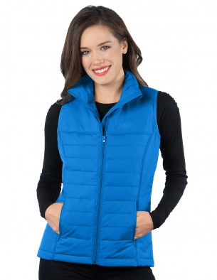 woman wearing bright blue quilted puffer vest over black long-sleeved tee
