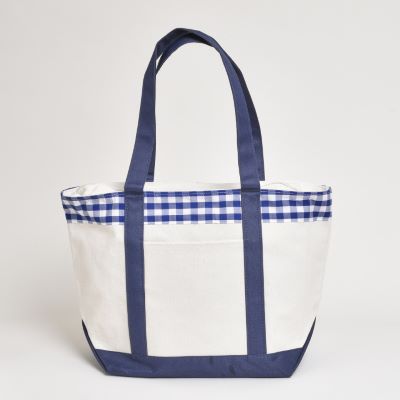 white canvas tote bag with navy blue base, handles and blue gingham (checkered) accent