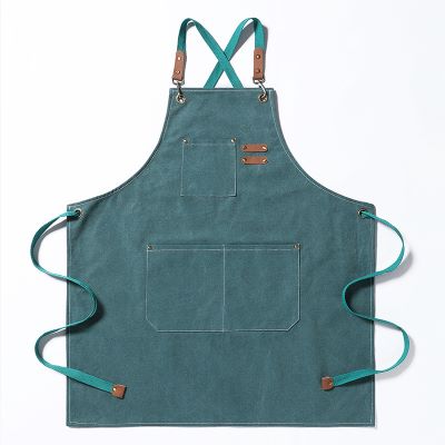 blueish-green canvas apron with leather accents